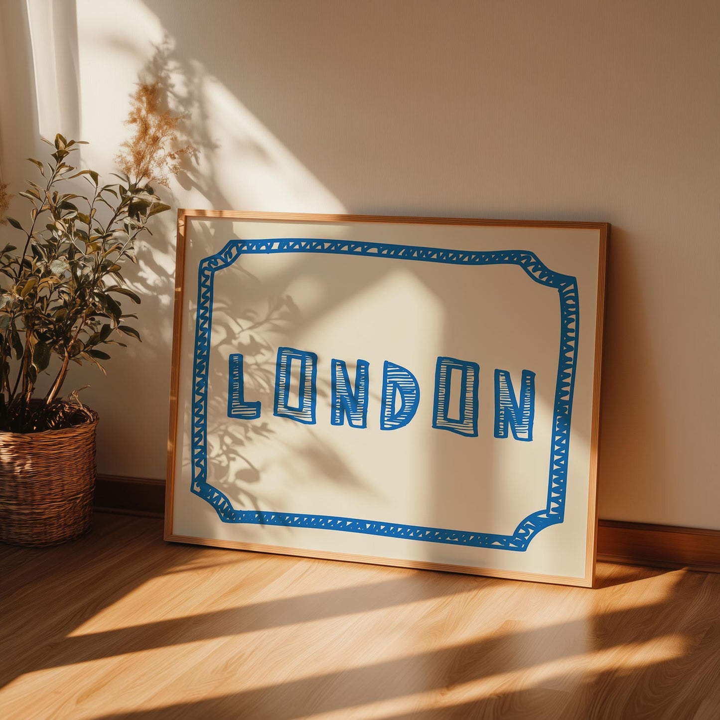 The word 'LONDON' in a funky, hand-drawn block font. Retro blue printable wall art on a cream background, framed by a sketchy border.