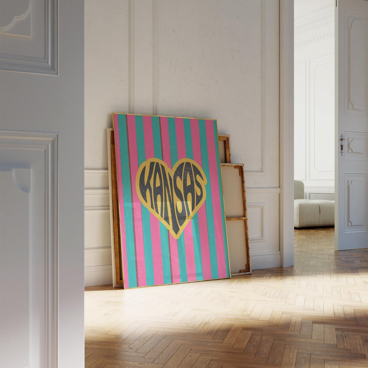 A heart-shaped design with the word 'Kansas' in groovy black retro font, outlined in yellow, set against a background of vertical pink and teal stripes.