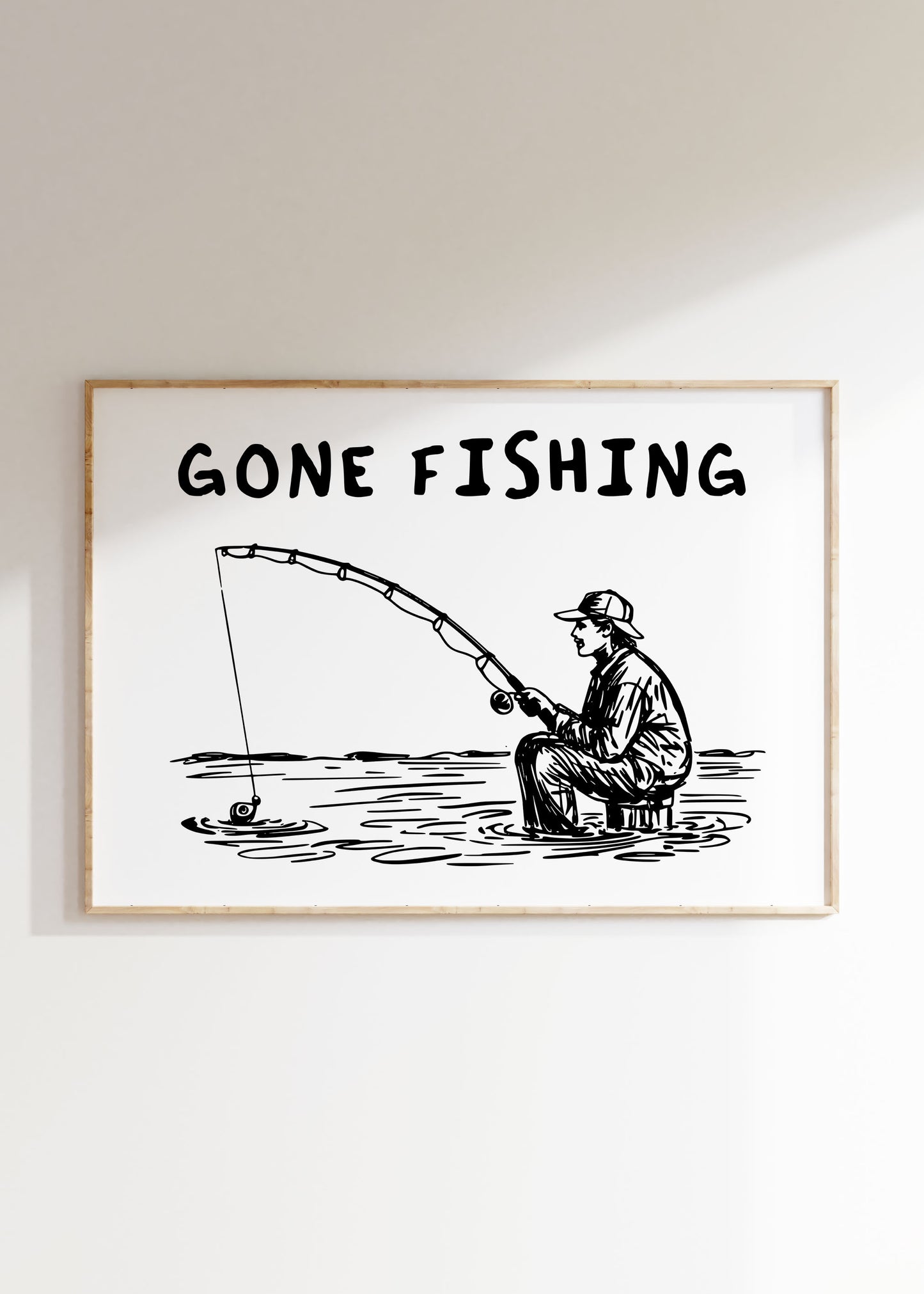Black and white line art print with a person fishing and the text "GONE FISHING".