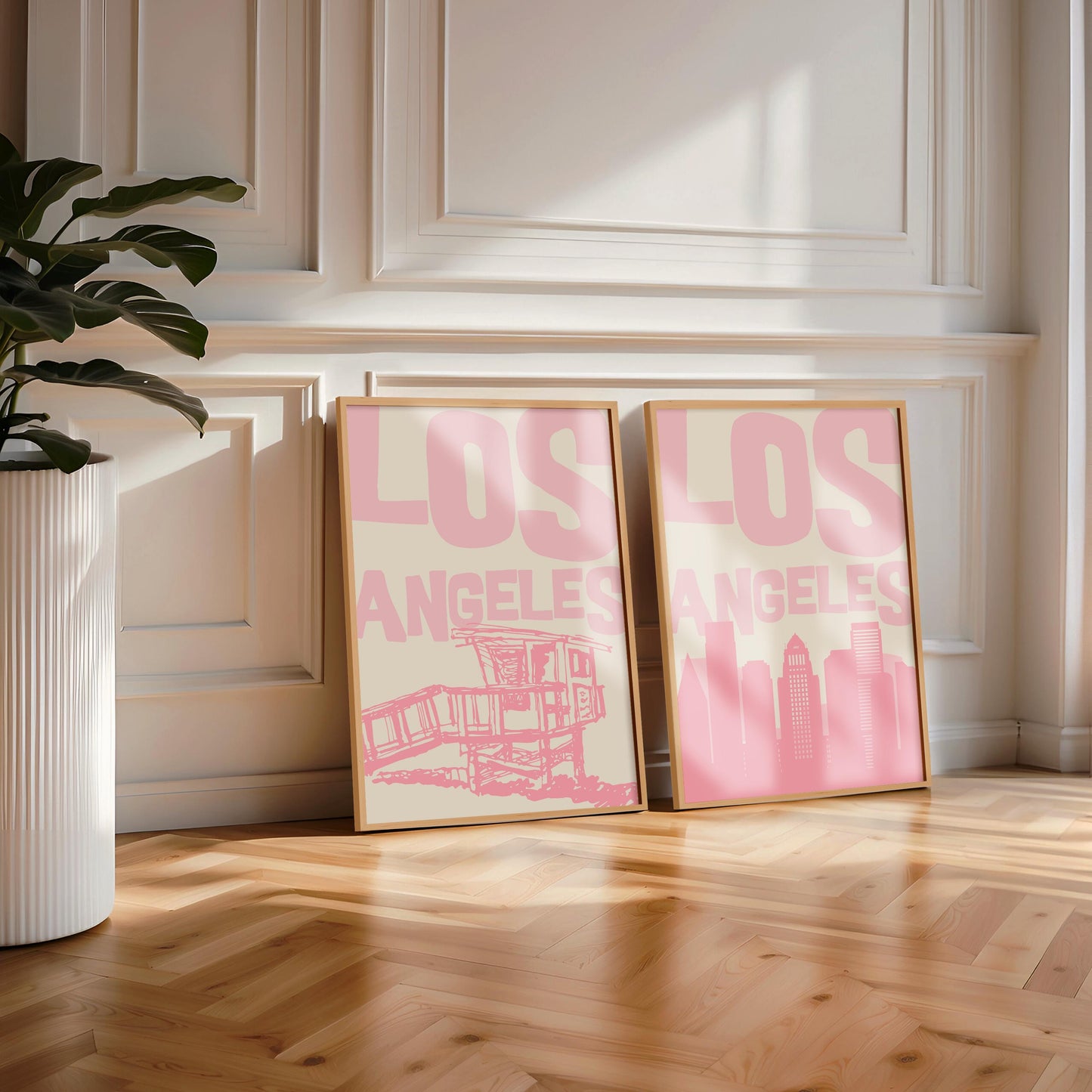 Set of two printable Los Angeles posters in pastel pink. Features the LA skyline and a lifeguard tower, perfect for a California gallery wall.