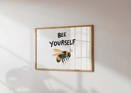 An inspirational bee print in a landscape frame, featuring a painterly bumblebee illustration under the quote 'Bee Yourself'.