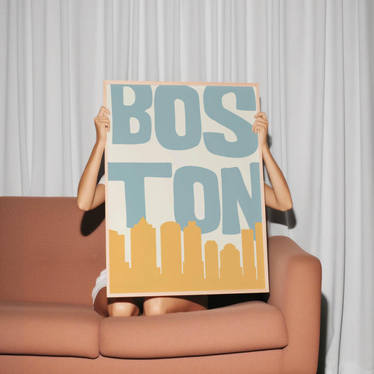 A retro Boston print featuring the word 'BOSTON' in teal above a minimalist yellow skyline on a cream background.