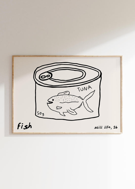 A minimalist line drawing of a tuna can, framed as kitchen wall art. The print includes the words 'fish' and 'still life'.