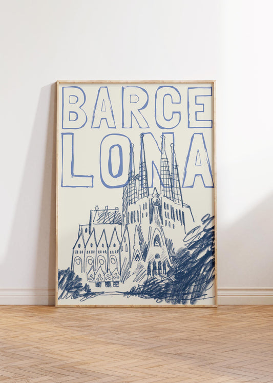 A Barcelona travel poster in a wood frame, with a blue sketch of the Sagrada Familia and the word 'BARCELONA' in a block font.