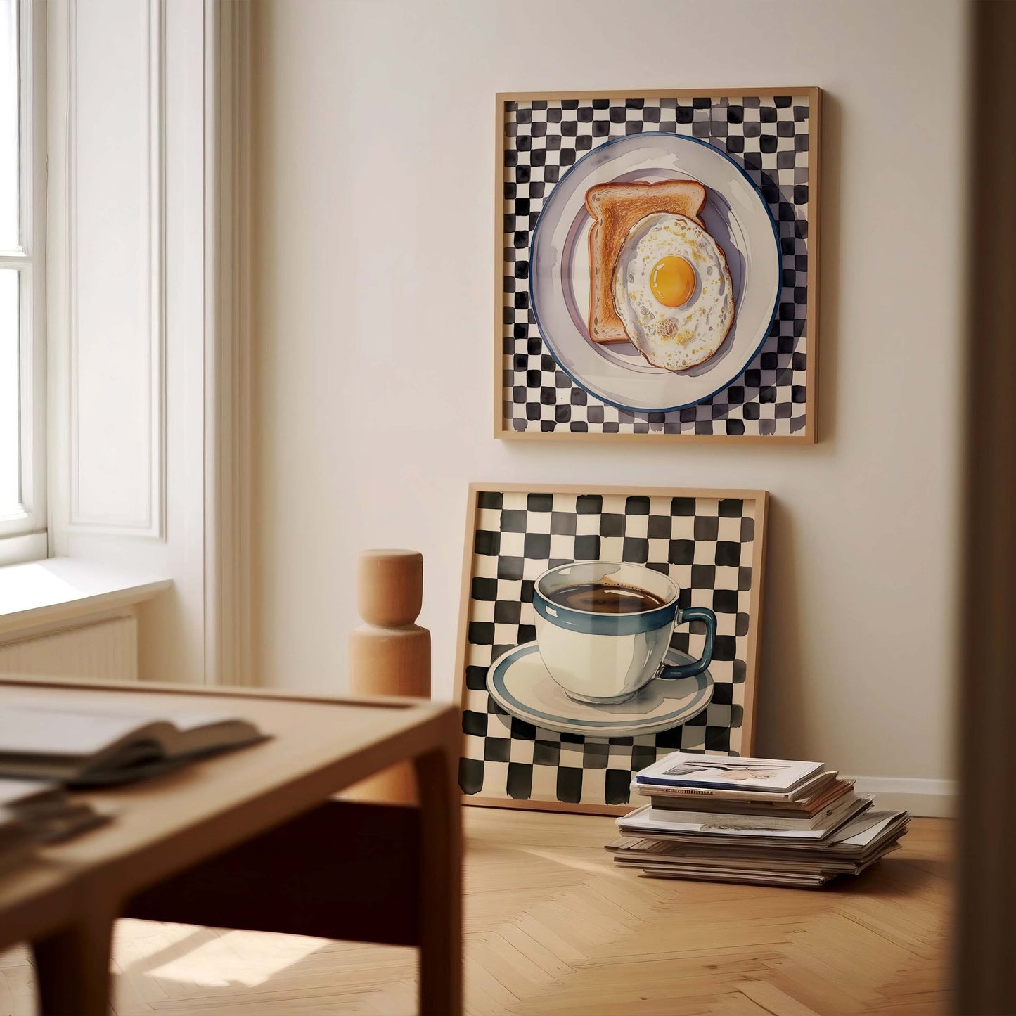 Room interior with framed artwork of a plate with toast and egg above a coffee cup and saucer.