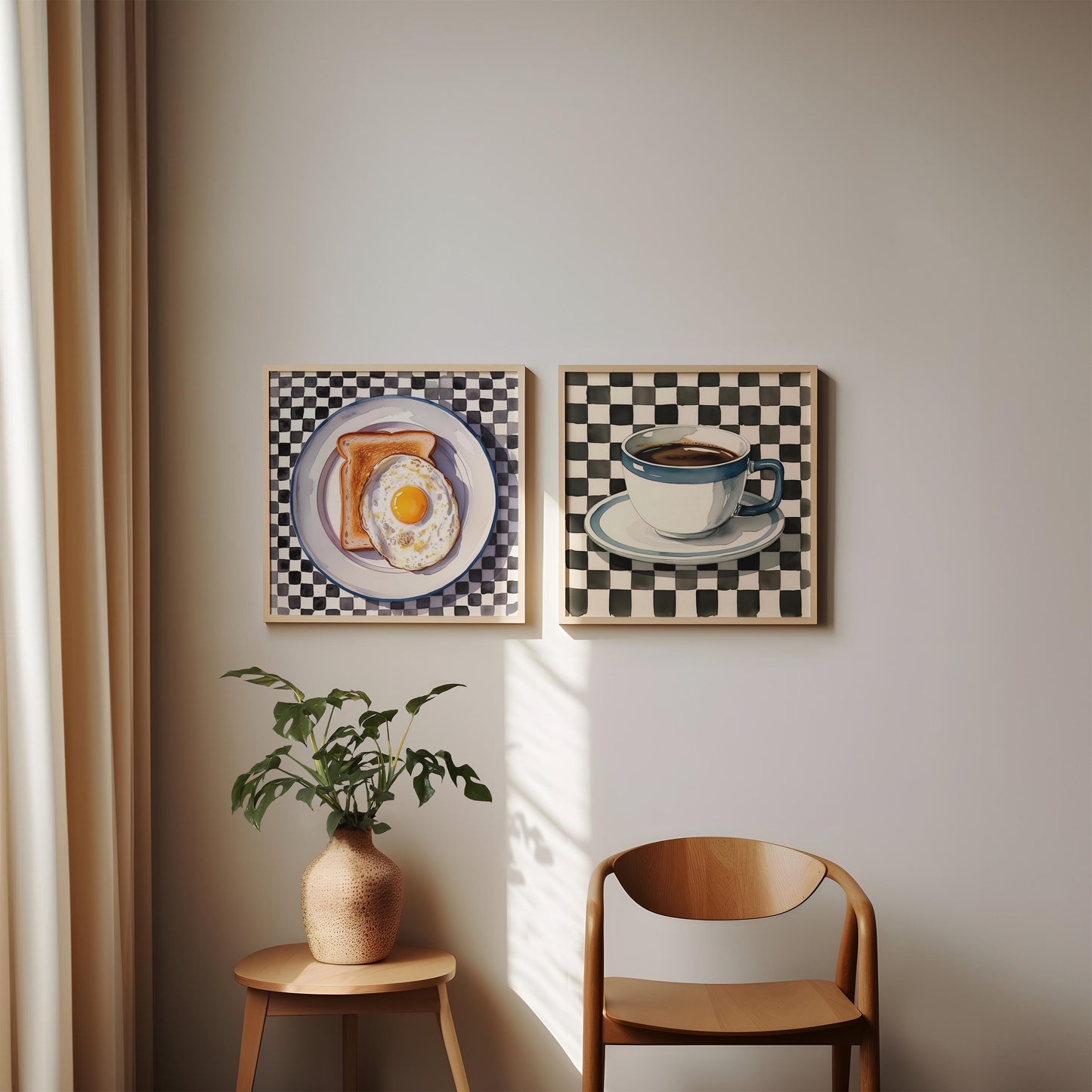Set of two checkered kitchen prints leaning against a wall. The printable wall art features a coffee cup and fried egg on toast.