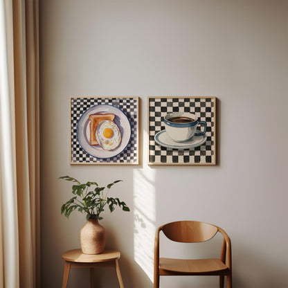 Set of two checkered kitchen prints leaning against a wall. The printable wall art features a coffee cup and fried egg on toast.